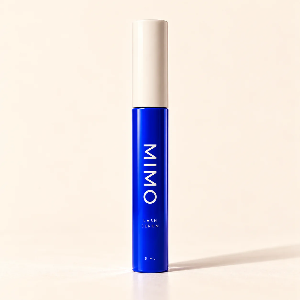 MIMO Lash Serum: a slim cobalt tube with a cream cap, standing upright.