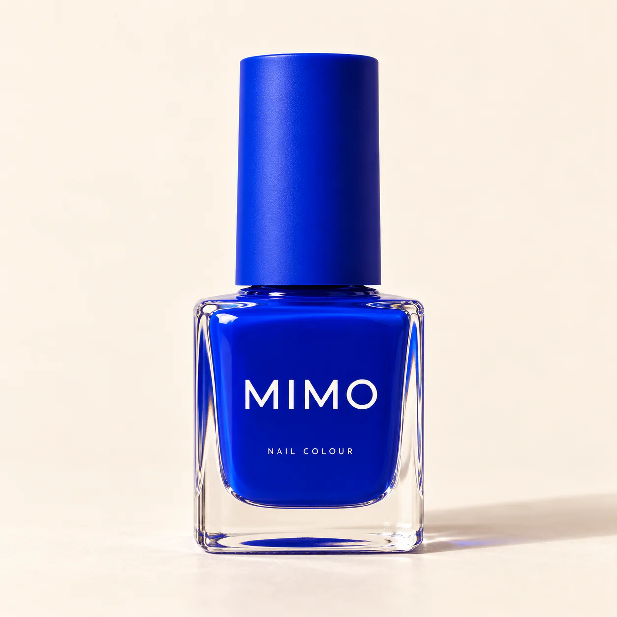 MIMO Nail Colour in Cobalt Blue: a square glass bottle with a matching cap on a cream background.