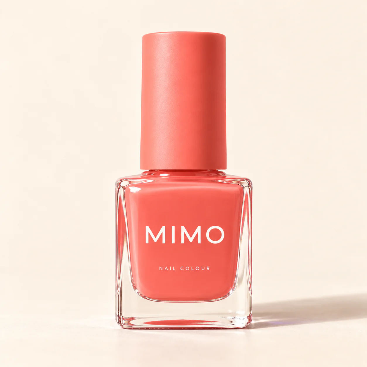MIMO Nail Colour in Coral: a square glass bottle with a matching cap on a cream background.