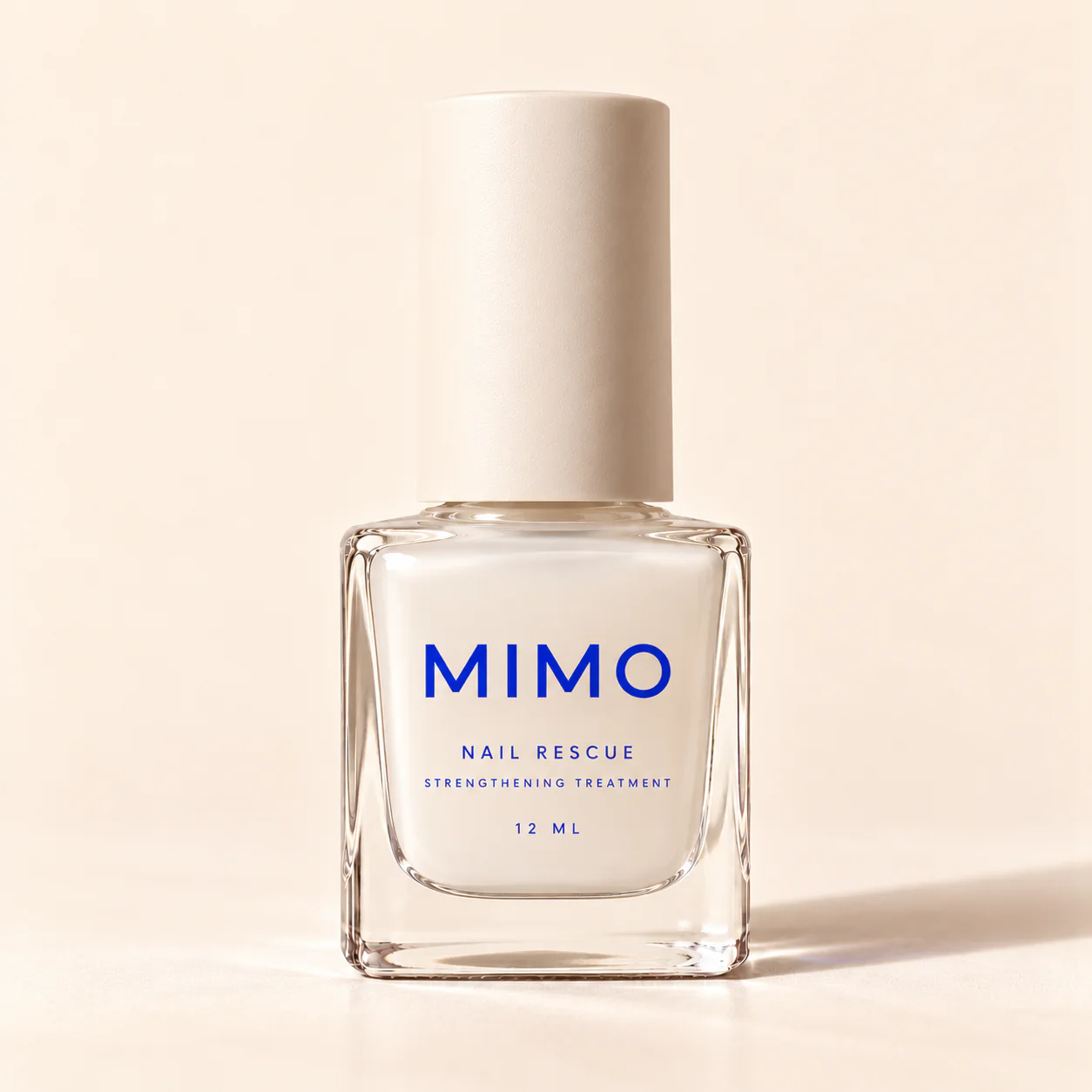 MIMO Nail Rescue Strengthening Treatment: a square glass bottle with a cream cap and cobalt lettering.